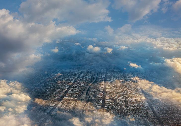 A city seen from above the clouds