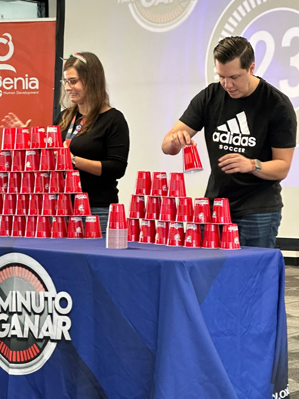 F5ers Ana Claudia Quevedo and Alan David Gomez stack as many paper cups as part of a team building exercise during Hispanic Heritage Month. F5ers Ana Claudia Quevedo and Alan David Gomez stack as many paper cups as part of a team building exercise during Hispanic Heritage Month.