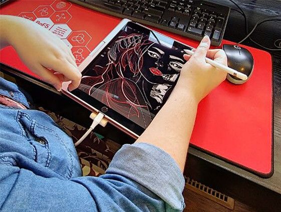 Rachel spending time on one of her creative endeavors, illustrating