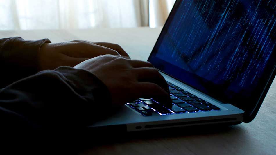 hand typing on laptop